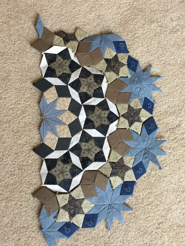 a circular piece of paper is laying on the floor with blue and brown stars around it