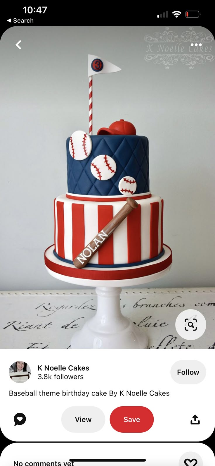 a red, white and blue cake with baseballs on it sitting on top of a table