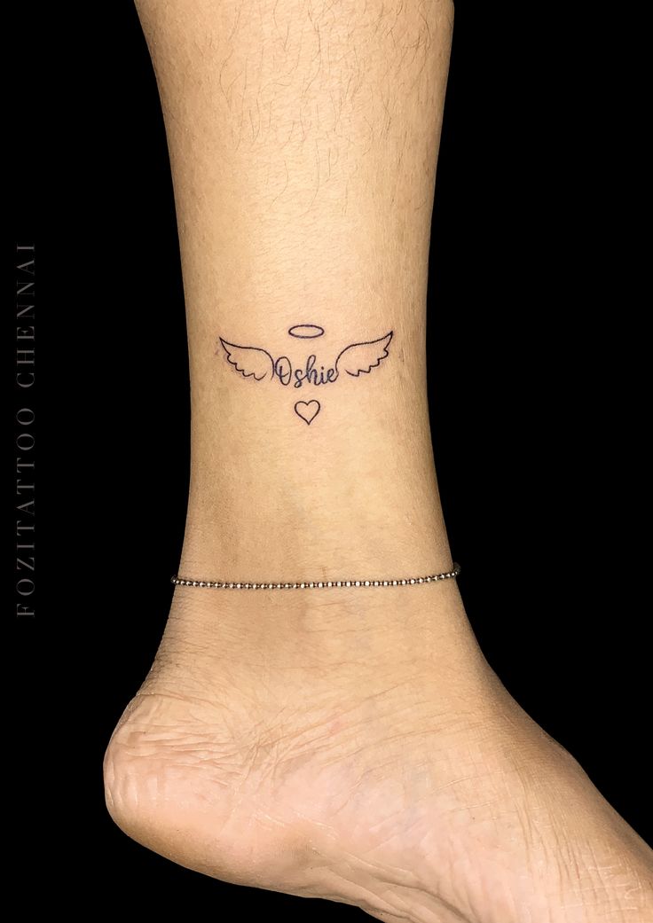 a small ankle tattoo with an angel wing