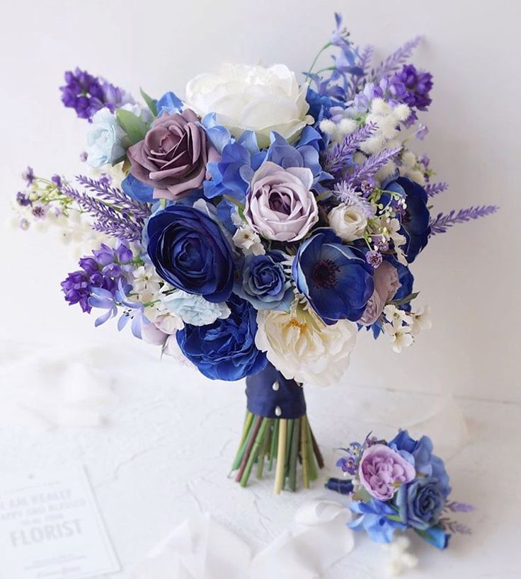 a bouquet of blue, purple and white flowers