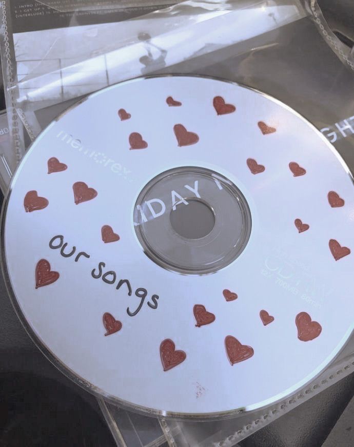 a cd that has hearts on it and the words today is oursongs written on it