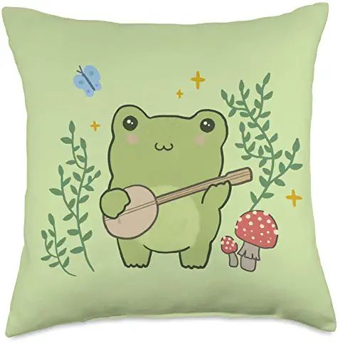 a green pillow with a cartoon frog holding a ukulele and mushroom on it