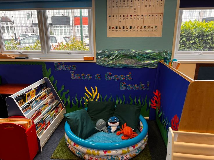 an inflatable pool is set up with books and toys for children to read