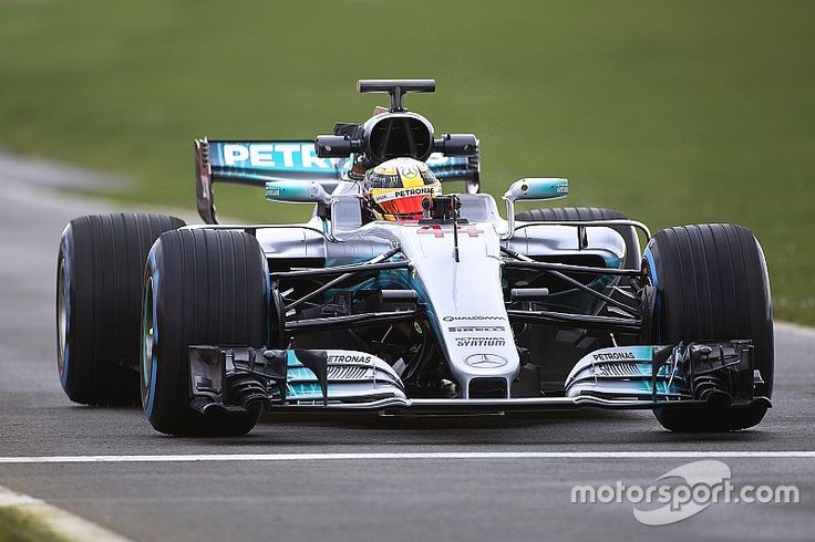 a man driving a racing car on a race track