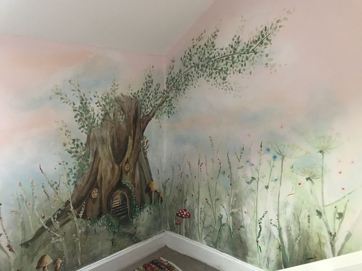 a room with a tree trunk painted on the wall next to a rug and carpet