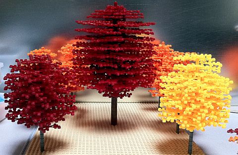 three trees in different colors on a table