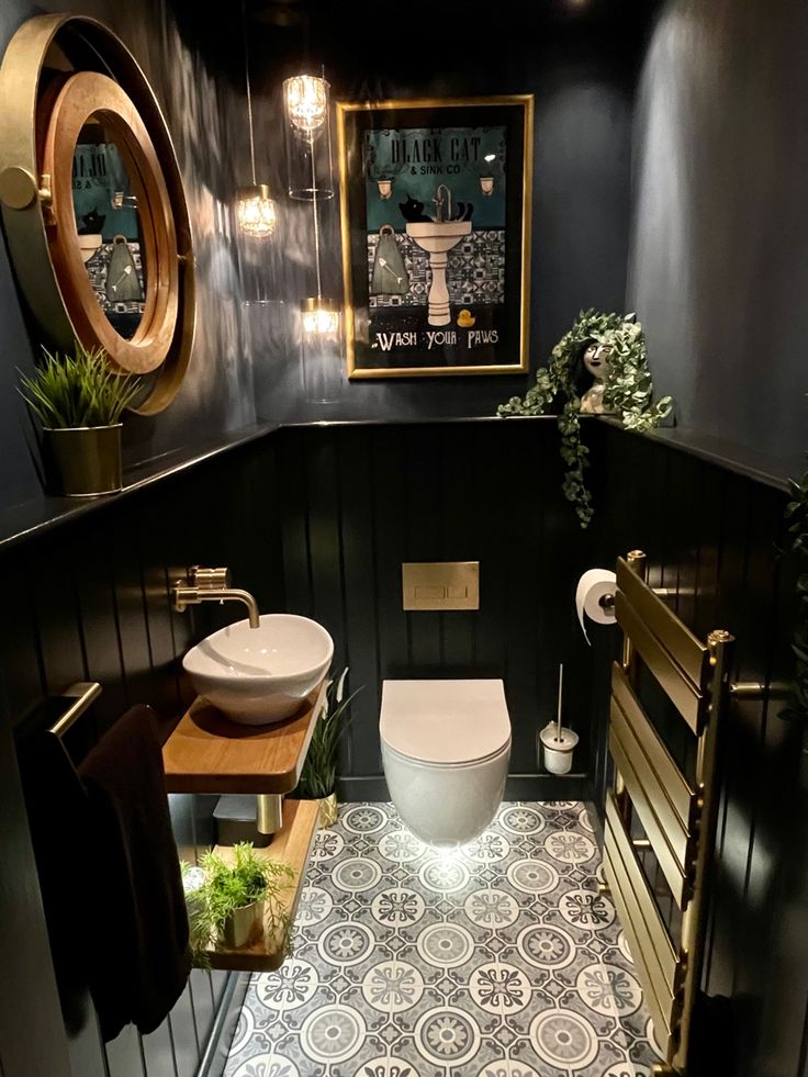 a bathroom with a toilet, sink and mirror on the wall next to a wooden bench