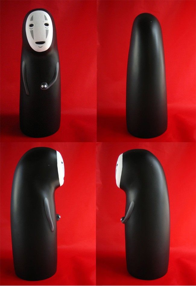 four different views of a black object with a white face on it's head