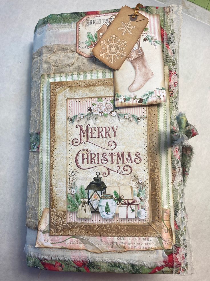 an altered christmas card is displayed on a table