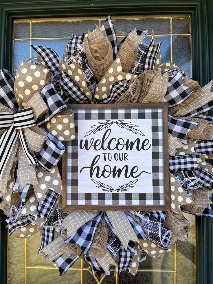 a welcome to our home wreath with polka dots and burlocks on the front door