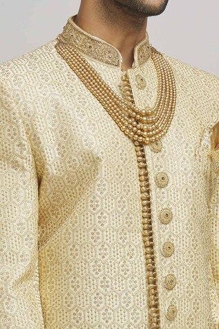 Ivory and golden sherwani with floral frame embroidery. Paired with an inner kurta and churidar. - Aza Fashions Gold Embroidered Sherwani For Diwali With Traditional Drape, Festive Sherwani With Gold Embroidery For Festivals, Festive Gold Embroidered Sherwani For Diwali, Ceremonial Sherwani With Gold Embroidery For Diwali, Traditional Sherwani With Gold Embroidery For Ceremonial Occasions, Gold Sherwani With Dupatta For Festive Occasions, Gold Churidar For Ceremonial Festivals, Ceremonial Gold Churidar With Pallu, Festive Gold Sherwani With Intricate Embroidery