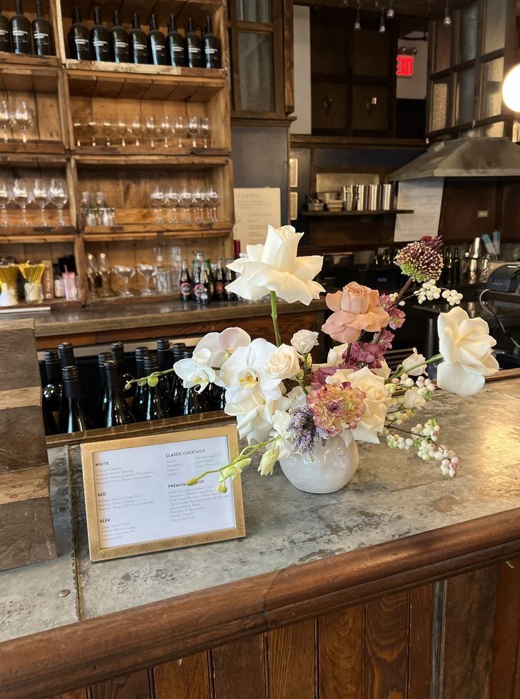 flowers in a vase sitting on top of a counter