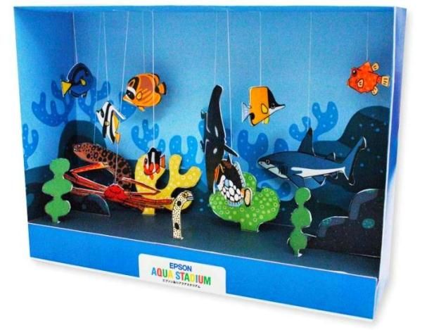 an ocean scene with fish and corals hanging from hooks on the wall in a cardboard box