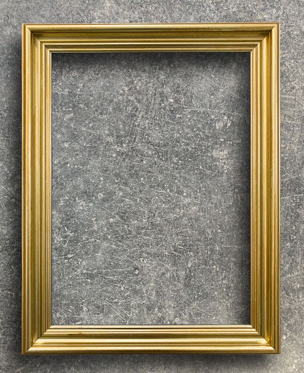 an empty gold frame hanging on the wall with a gray stone floor in front of it