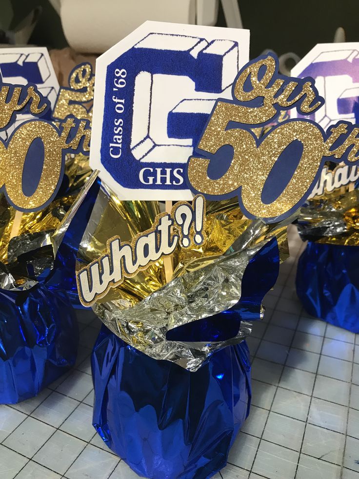 some blue and gold foil wrapped presents with the number fifty six on them for someone's 50th birthday