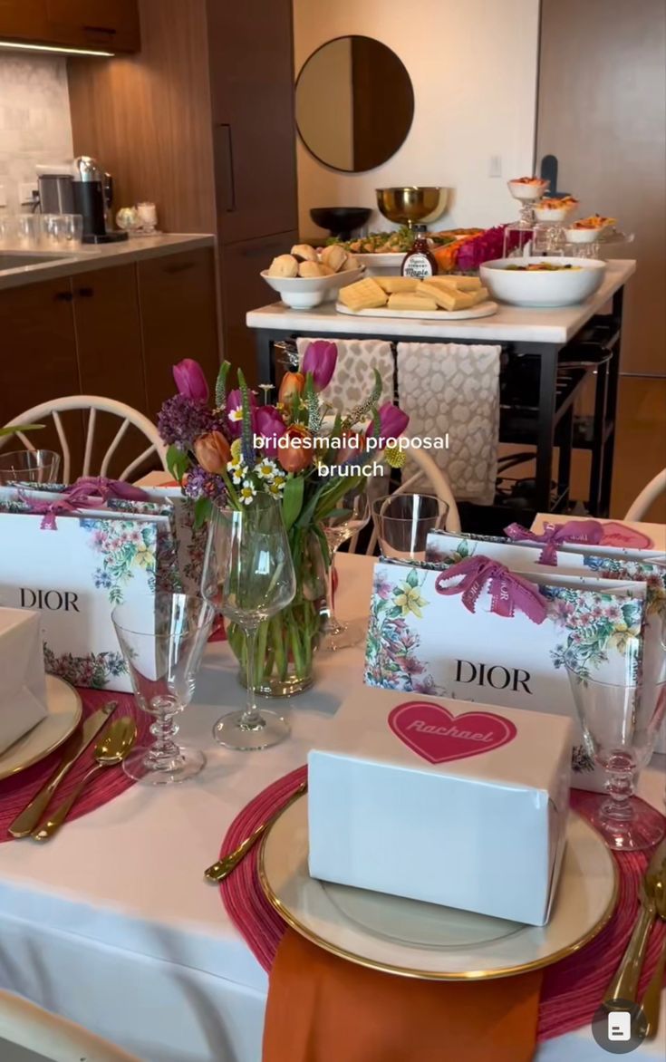 the table is set with flowers and place settings