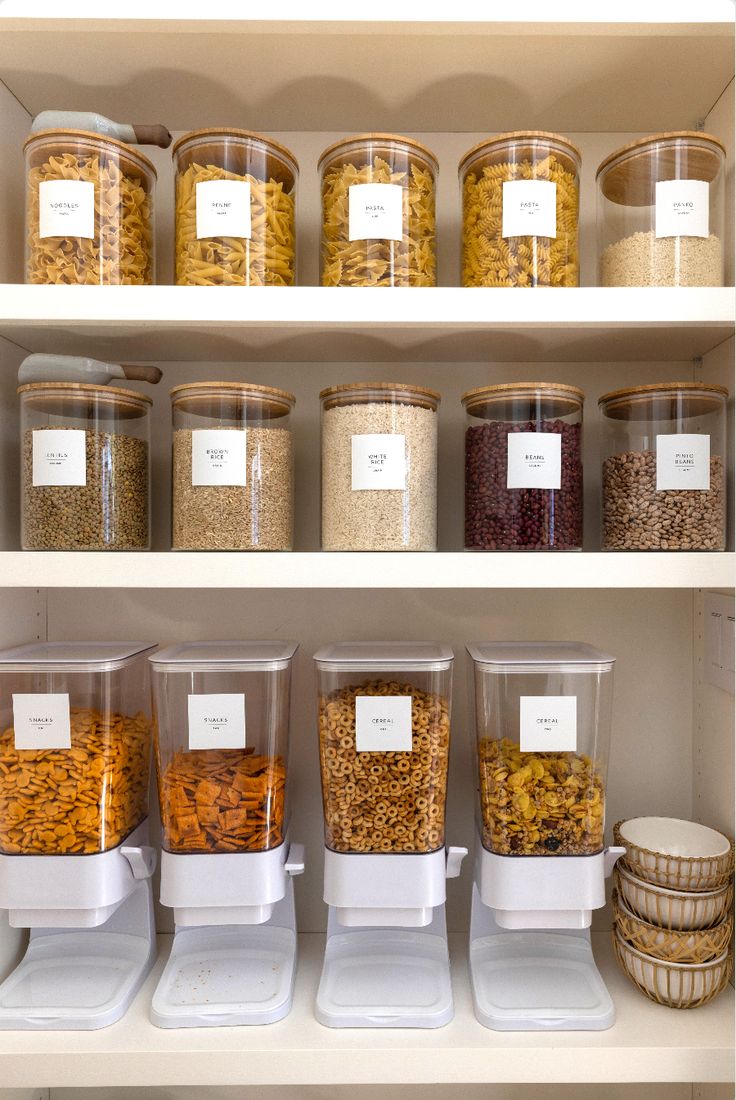 the shelves are filled with many different types of cereals and other food in plastic containers