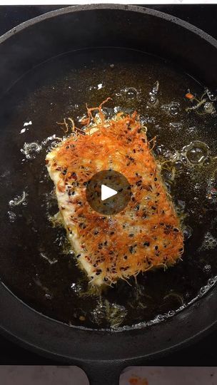 a frying pan with food cooking in it on top of a stove burner