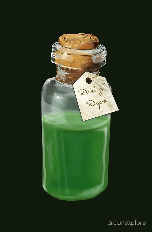 a bottle filled with green liquid next to a wooden cookie on top of a tag