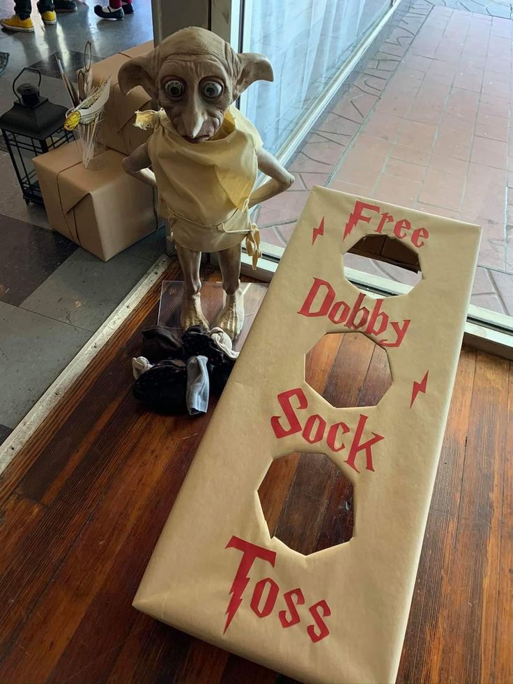 a dog dressed up as harry potter with a door to hog's dobby