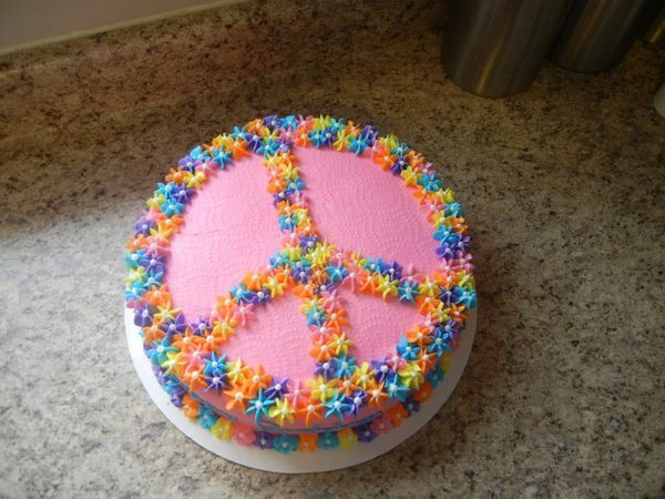 a peace sign cake with sprinkles on it