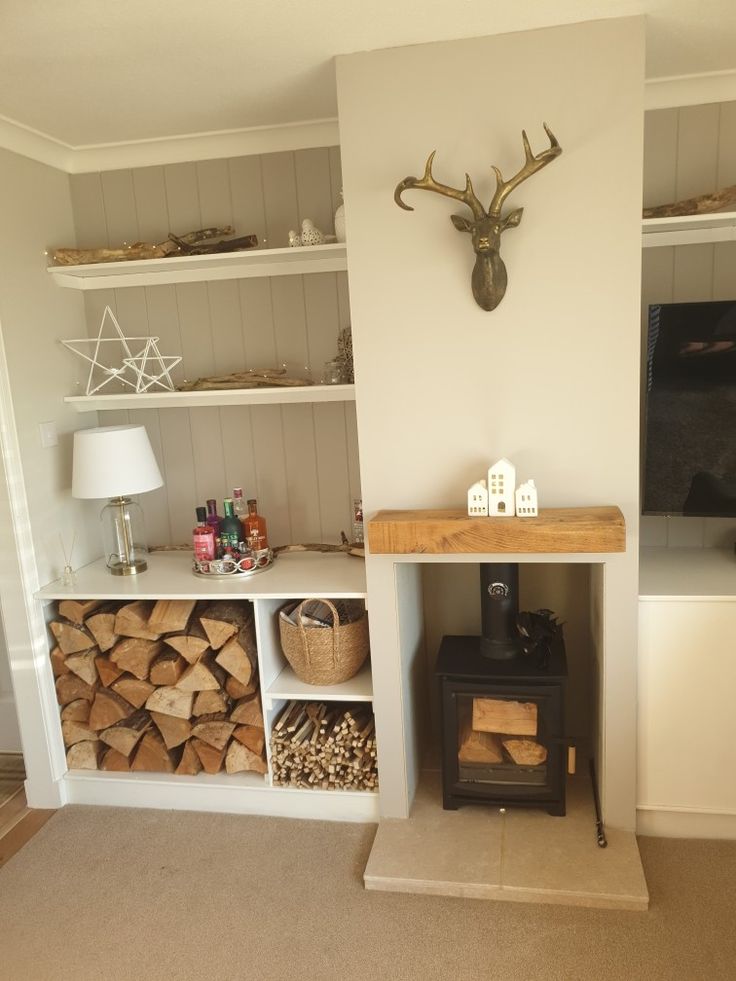 a living room filled with lots of furniture and wood stacked on top of each other