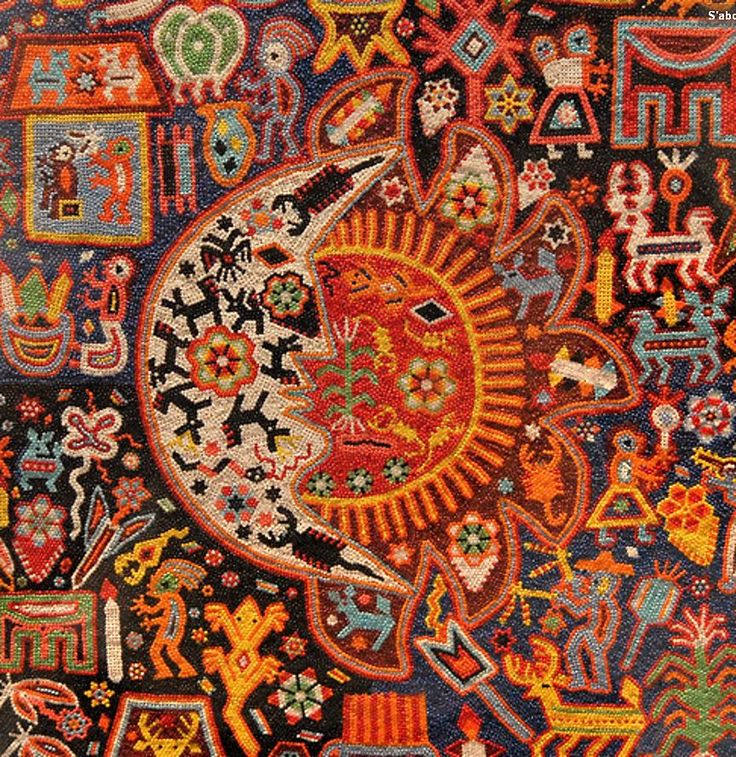 an intricately designed rug with many different colors and designs on the surface, including animals