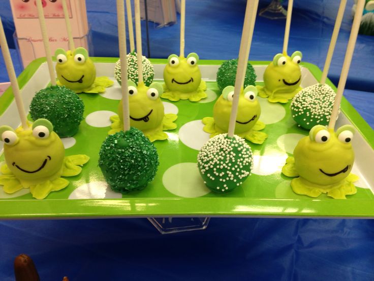 there are many green cake pops with faces on them