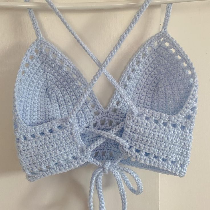 a crocheted bra hanging from a hook