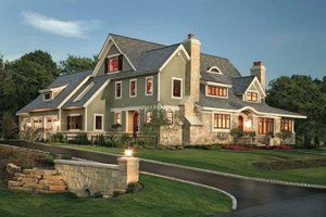 a large house with lots of windows in the front yard