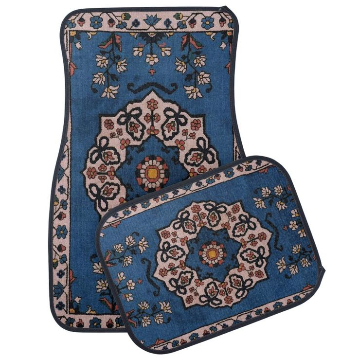 two blue rugs with floral designs on the front and back, one has a flower design