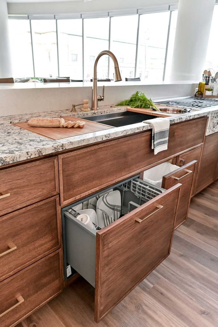 an open dishwasher drawer in a kitchen