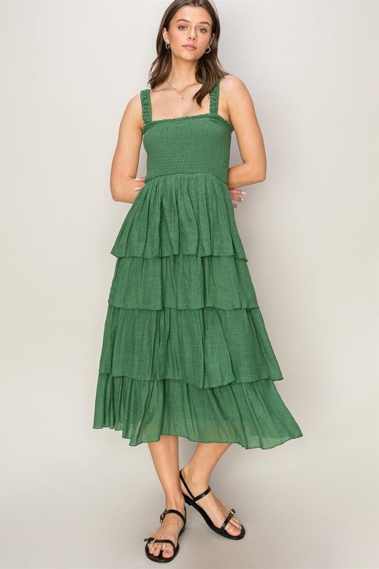 DRESS YOURSELF IN THE SUN OF SUMMER WITH THIS MIDI DRESS. THE SMOCKED BODICE IS FRAMED WITH A RUFFLE-ADORNED SQUARE NECK AND SHOULDER STRAPS FOR A DELICATE TOUCH, WHILE THE QUAD-TIERED LAYERED SKIRT ADDS FLOUNCY MOVEMENT TO YOUR EVERY STEP. 100% POLYESTER MODEL IS 5' 7" TALL, 32" CHEST, 25" WAIST AND 35" HIPS AND WEARING a SIZE SMALL Flannel Tops, Layered Skirt, Graphic Tops, Resort Wear, Plus Size Tops, Outerwear Jackets, Short Tops, Green Dress, Sweater Top