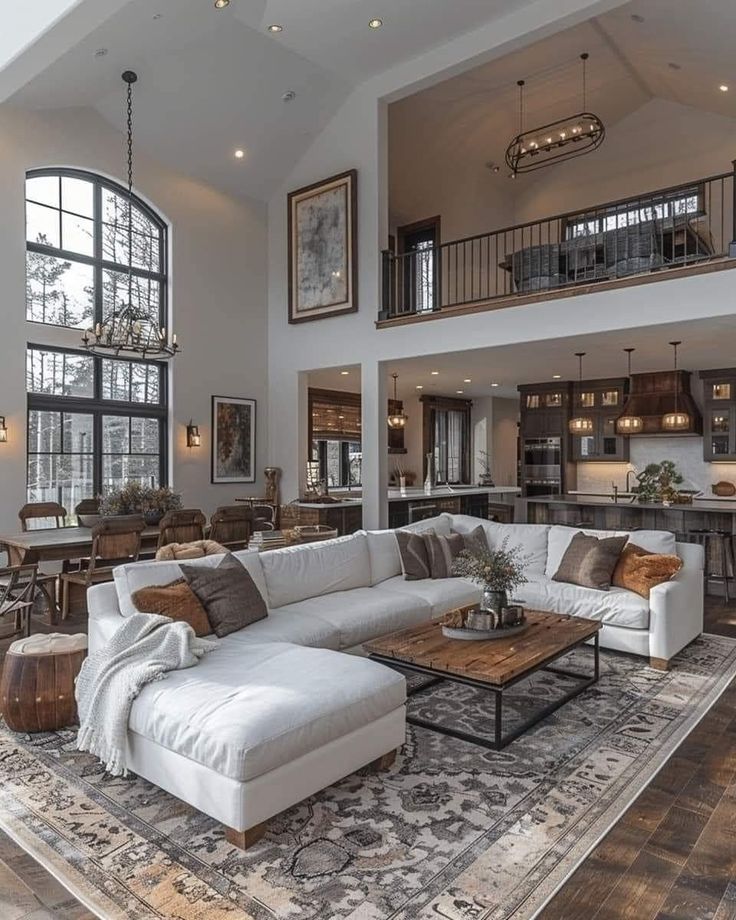 a living room filled with furniture and large windows