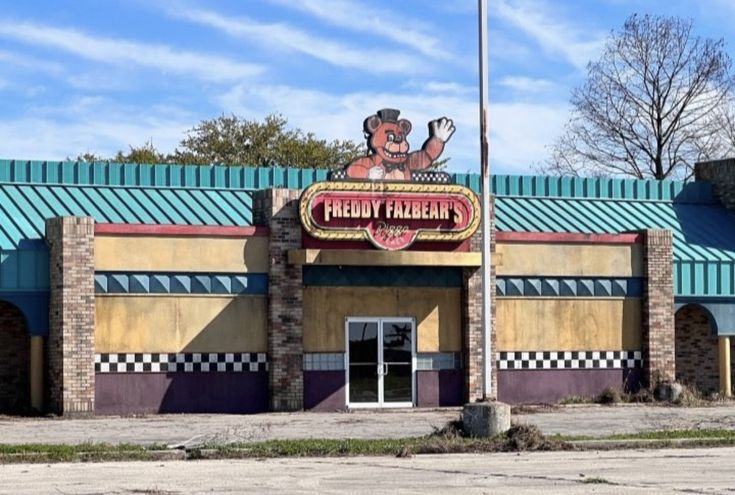 the front of a restaurant with a large sign on it's roof and windows