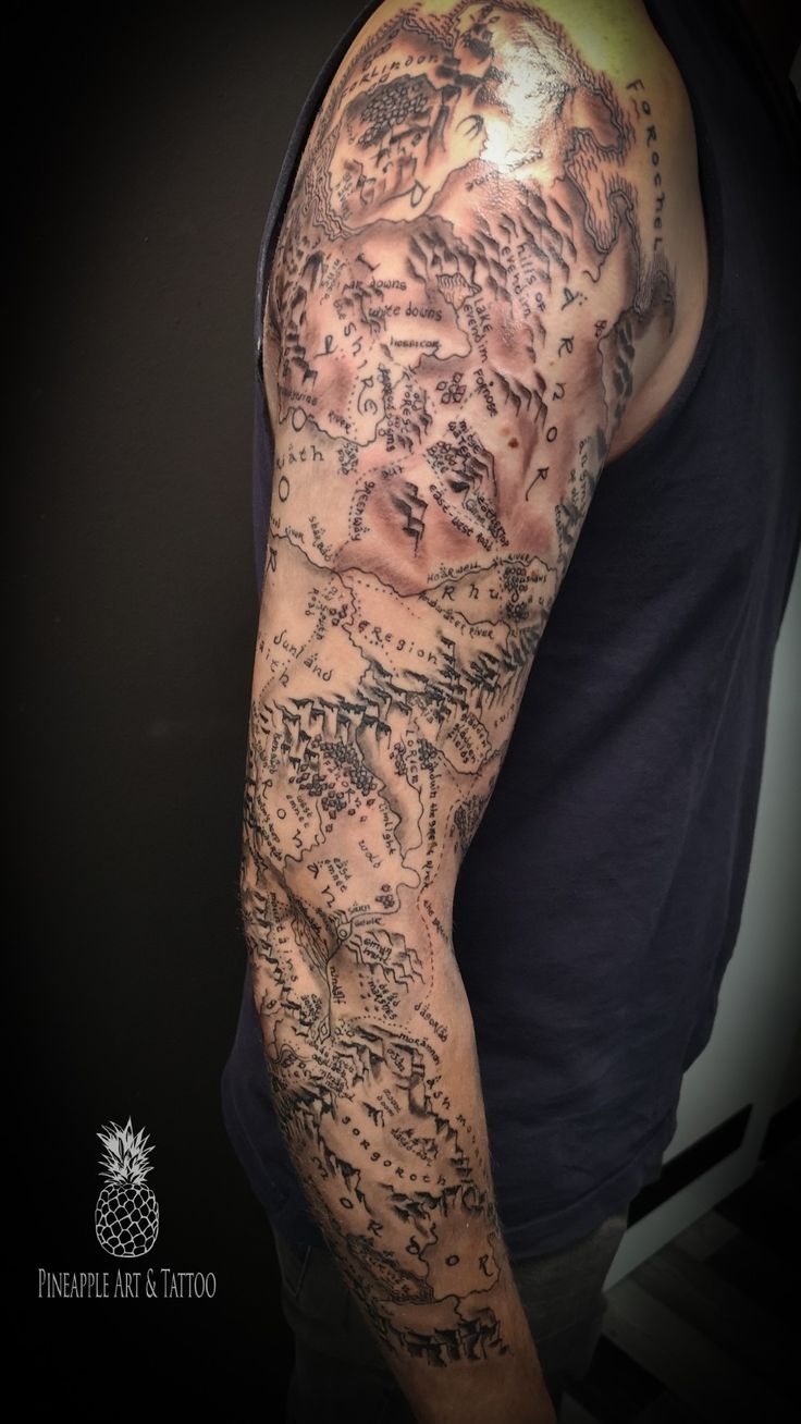 a man's arm covered in lots of writing and ink on his left arm