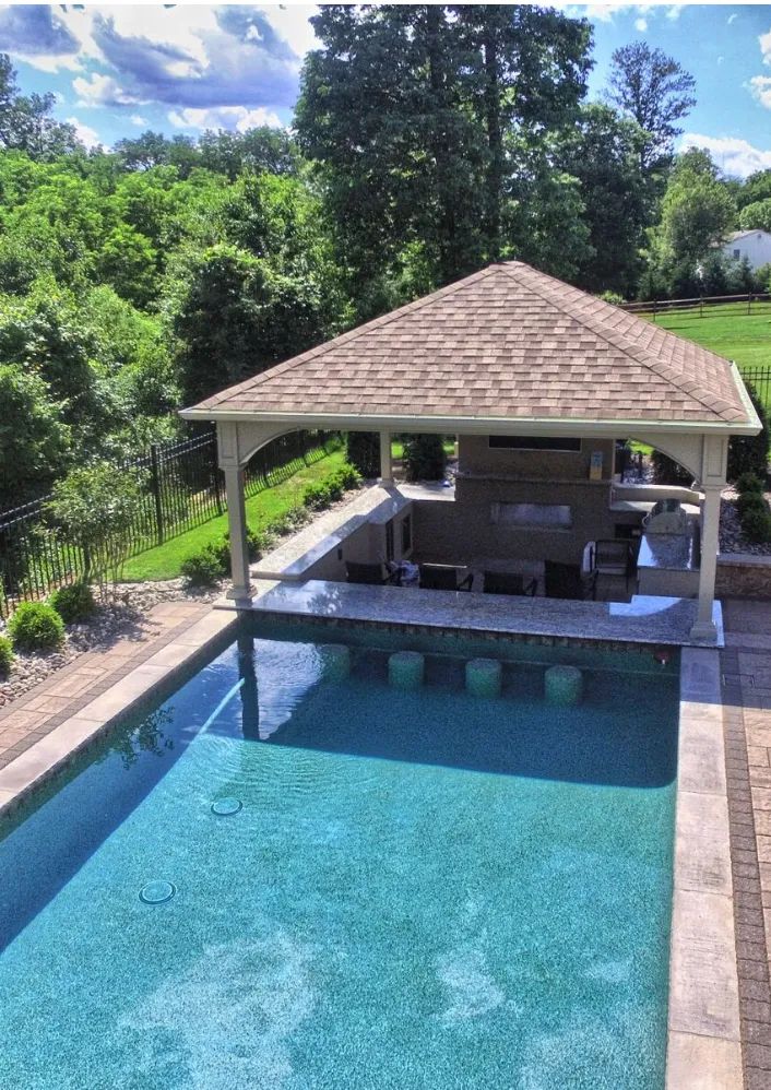 an above ground pool with a gazebo in the middle