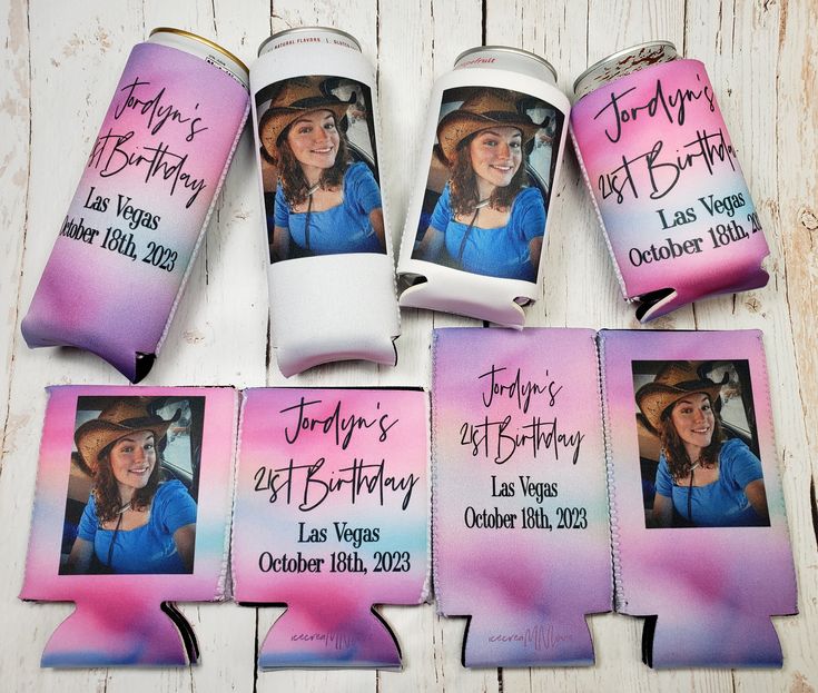 the birthday party favors are decorated with pink and blue watercolors, including two cans