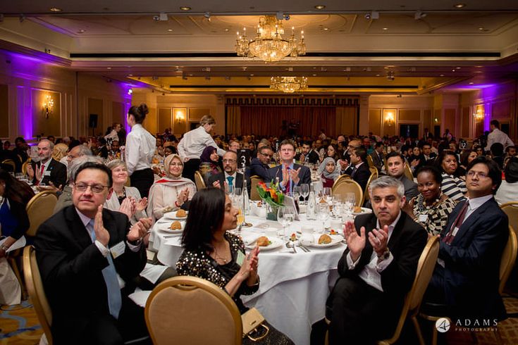 a large group of people sitting around tables