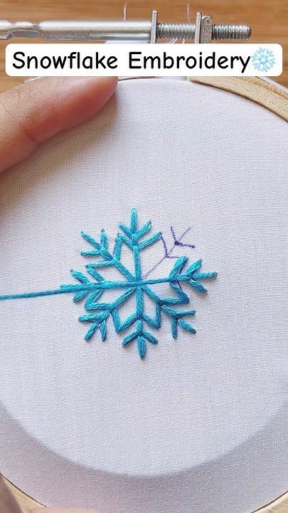 someone is stitching a snowflake embroidery pattern