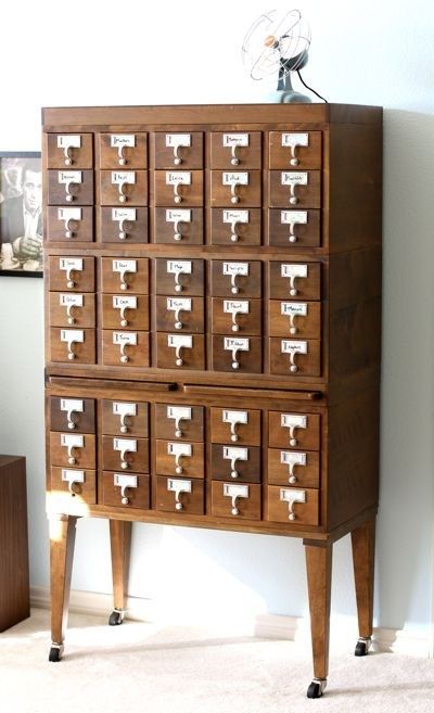 a tall wooden cabinet with many drawers