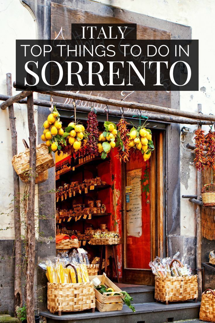 an outdoor market with baskets and fruit on display in front of the store's door