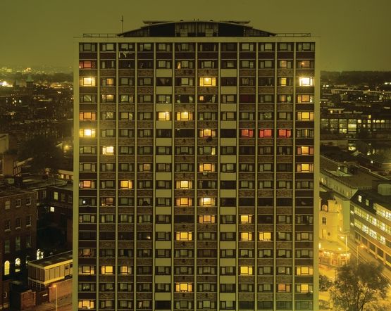 a tall building with many windows lit up at night