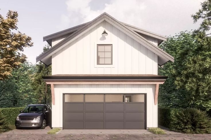 a car is parked in front of a house with two garages on each side