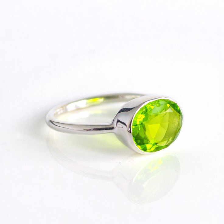 You'll fall in love with the intense grass-green color of this Peridot Quartz ring. This is a perfectly sized oval to compliment any collection. Popular as a birthday gift for those August babes and peridot lovers alike. This is a bright, transparent green gemstone with no flaws. This stone is beautifully faceted and bezel set in a 925 sterling silver band or plated with 18k vermeil gold. Gemstone is approximately 8 x 12mm.Band has 925 stamp on inside.Please note that each ring is handmade and t Stackable Gemstone Rings, August Birthstone Ring, Green Gemstone Ring, Peridot Jewelry, August Birthstone Jewelry, August Birthstone, Peridot Ring, Green Peridot, August Birth Stone