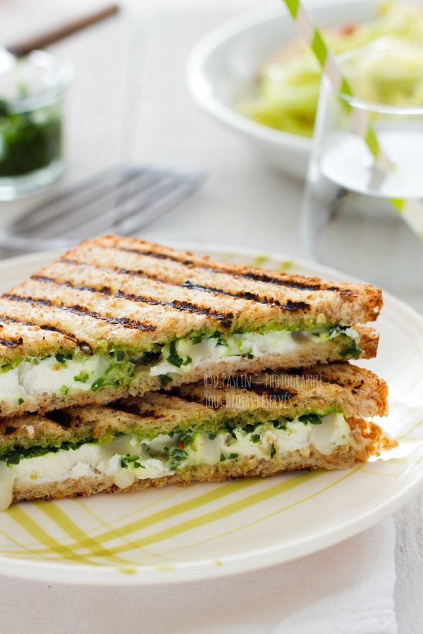 a grilled cheese and pesto sandwich on a plate