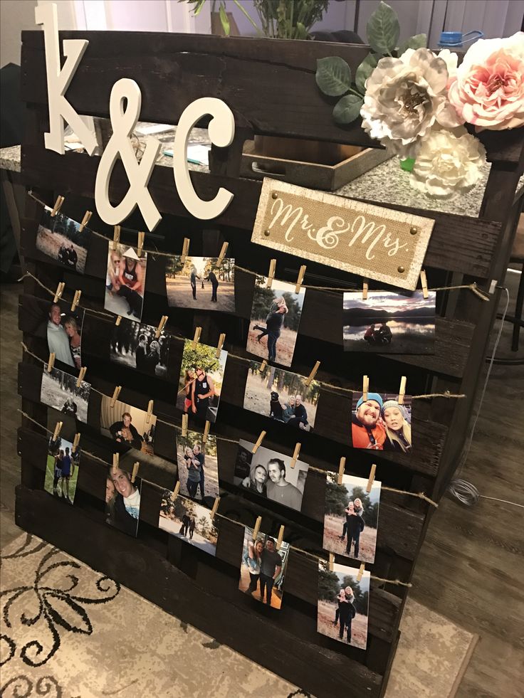 a couple's wedding photo display with clothes pins attached to the pegs that hold photos