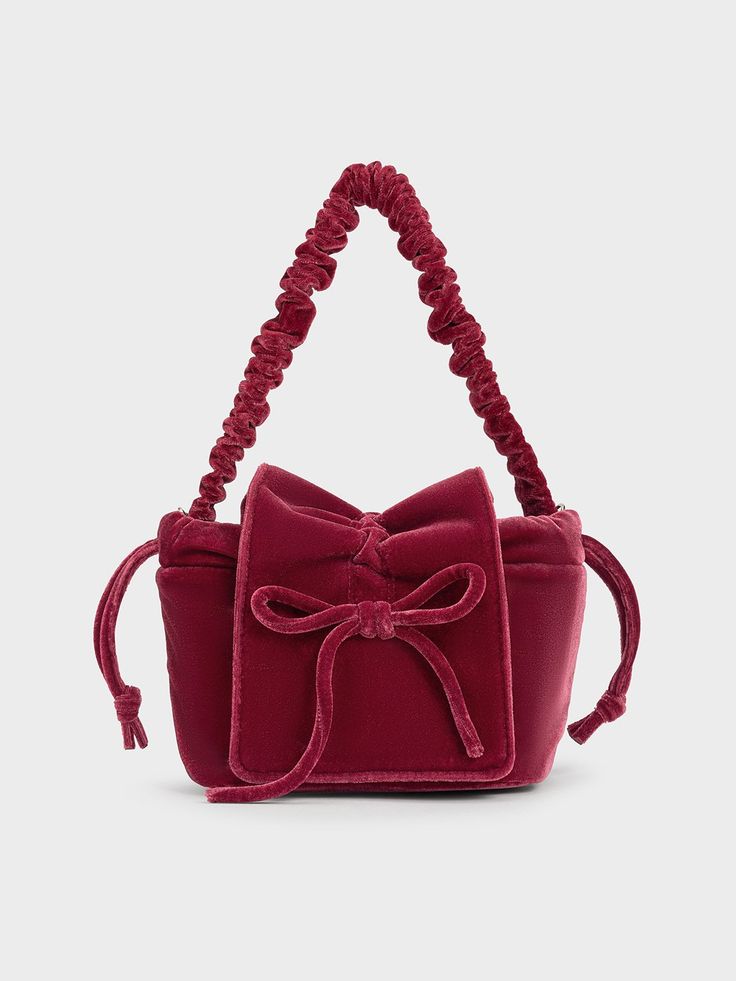 If you are looking to add a pop of colour to your look, this elegant pink top-handle bag is a sensible choice. It features a simple, classic pouch silhouette that allows the design details -- including the ruched handle and dainty bow embellishment -- to shine. Carry it by hand for a polished look or tuck it under the arm for hands-free convenience. You can always count on the velvety soft finish to complete your look with sophistication. Belt Ring, Ruched Top, Bags Shop, Charles Keith, Velvet Bow, Handbags Online, Wallet Accessories, Pink Velvet, Handle Bag