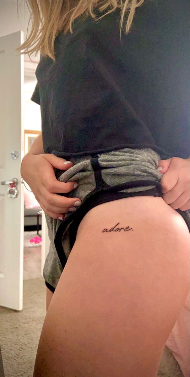 a woman's thigh with the word love written on it and her lower leg