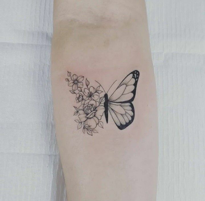 a butterfly and flowers tattoo on the arm